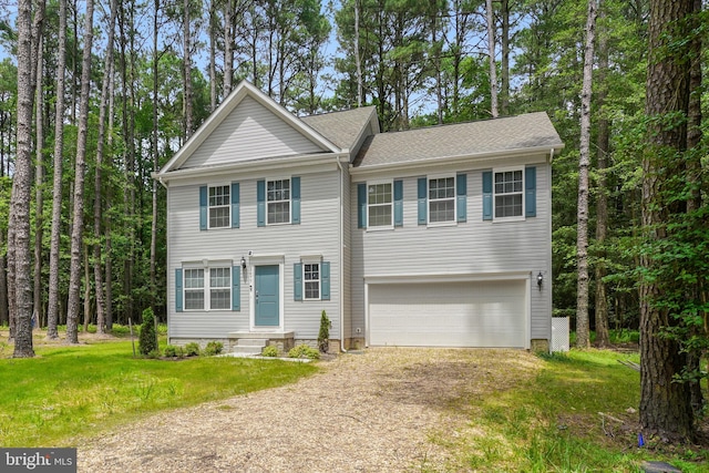 view of front facade featuring a front yard and a garage