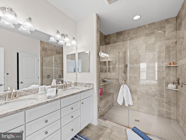 bathroom featuring walk in shower, vanity, and tile patterned flooring