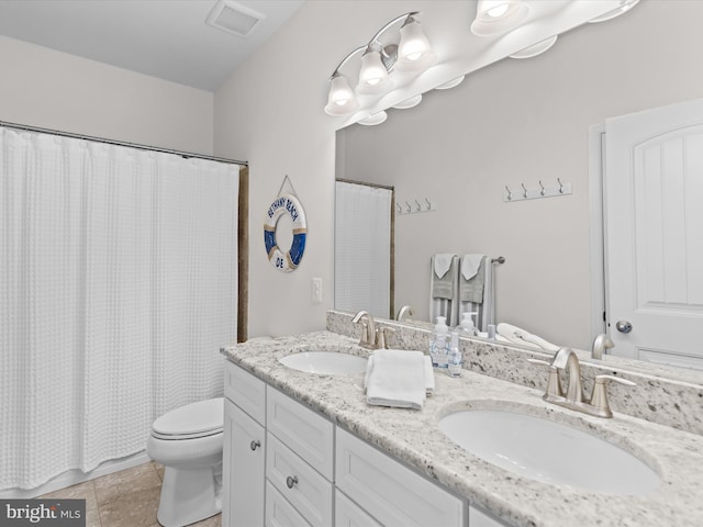 bathroom featuring tile patterned flooring, a shower with curtain, vanity, and toilet