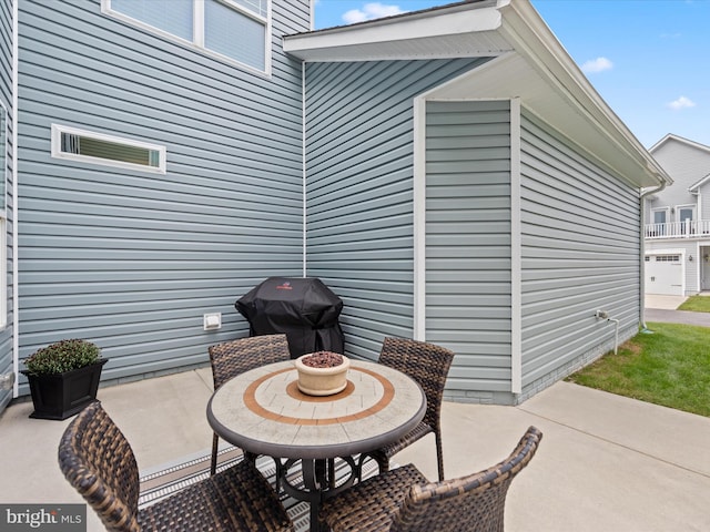 view of patio featuring area for grilling and a garage