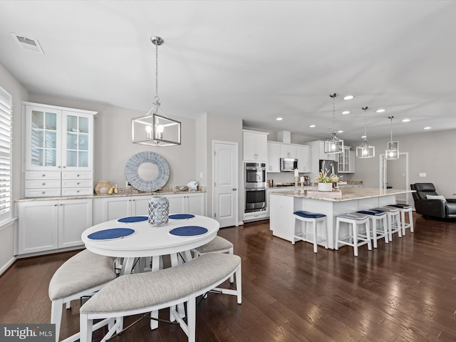 dining space featuring dark hardwood / wood-style floors