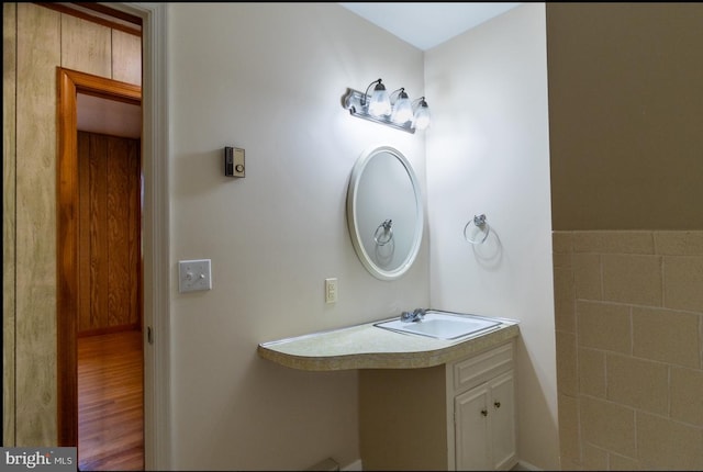 bathroom with hardwood / wood-style floors and vanity