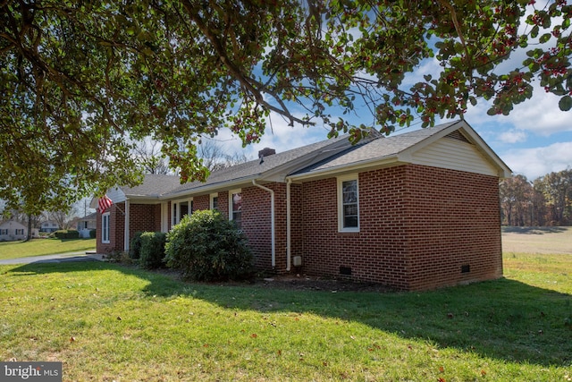 view of side of property with a lawn