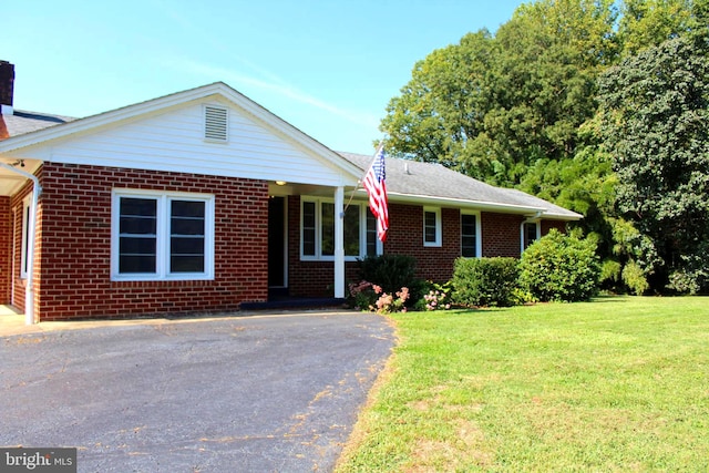 ranch-style house with a front lawn