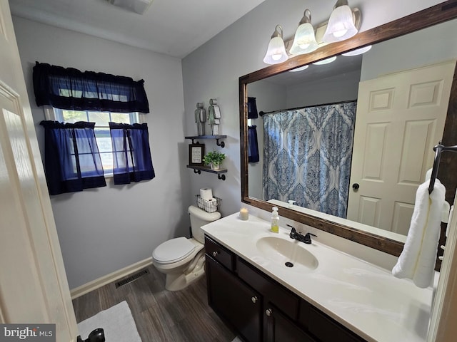 910 Sapphire Ct, Salisbury, MD 21804 - full bathroom with wood finished floors, vanity, toilet, baseboards, and curtained shower