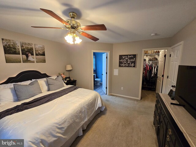 910 Sapphire Ct, Salisbury, MD 21804 - bedroom featuring a walk in closet, light colored carpet, baseboards, a closet, and ceiling fan