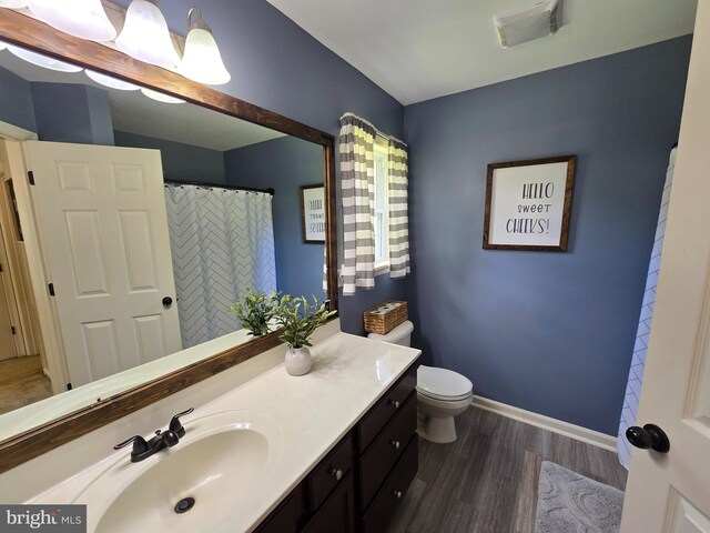 910 Sapphire Ct, Salisbury, MD 21804 - bathroom featuring vanity, wood finished floors, toilet, and baseboards