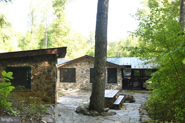 rear view of property with a patio and a deck