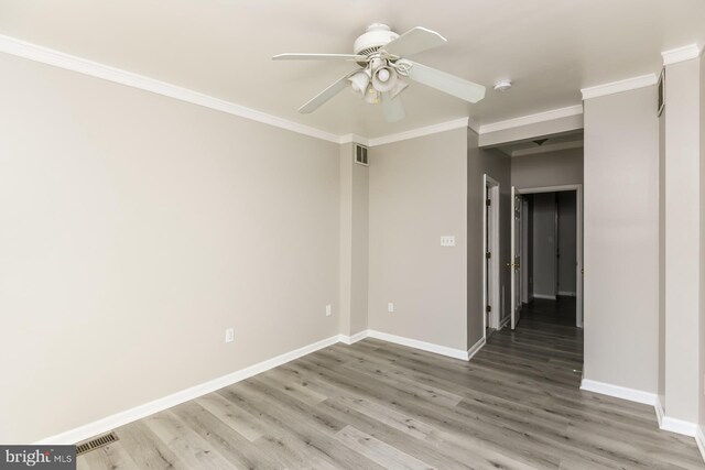 unfurnished room featuring ornamental molding, wood-type flooring, and ceiling fan