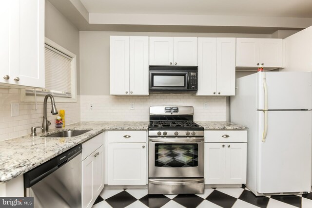 kitchen featuring stainless steel appliances, white cabinets, and sink