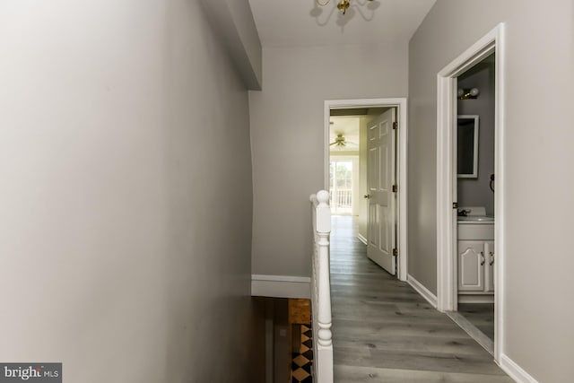 hall featuring wood-type flooring and sink