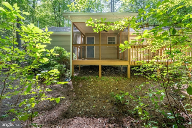 rear view of property with a wooden deck