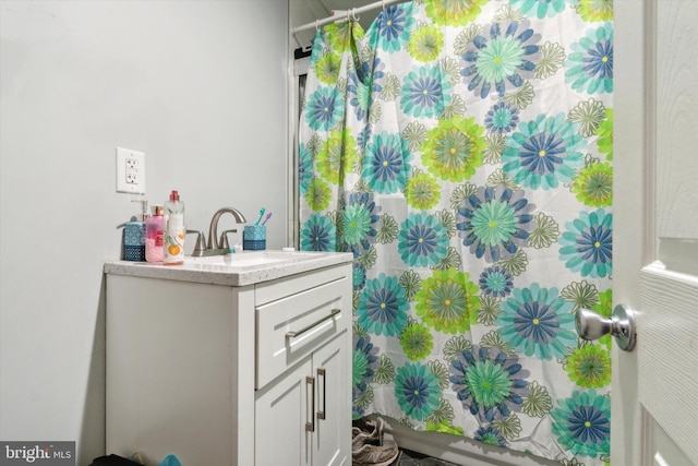 bathroom with walk in shower and vanity