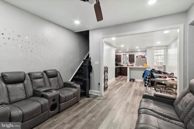 living room with light wood-type flooring, ceiling fan, and cooling unit