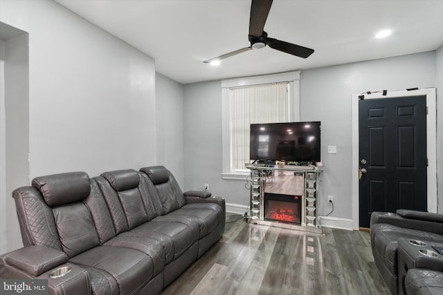 living room with wood-type flooring and ceiling fan