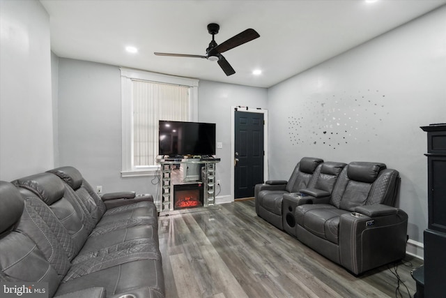 living room featuring ceiling fan and hardwood / wood-style flooring