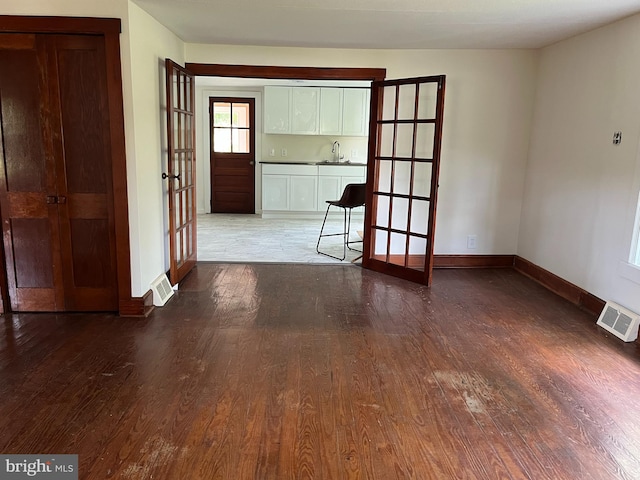 interior space with hardwood / wood-style floors, sink, and french doors