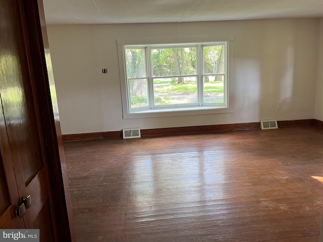 empty room with hardwood / wood-style flooring