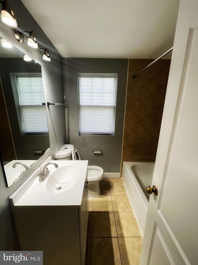 full bathroom with tiled shower / bath, vanity, toilet, and tile patterned flooring