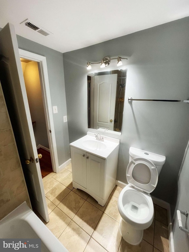 bathroom featuring vanity, toilet, and tile patterned floors