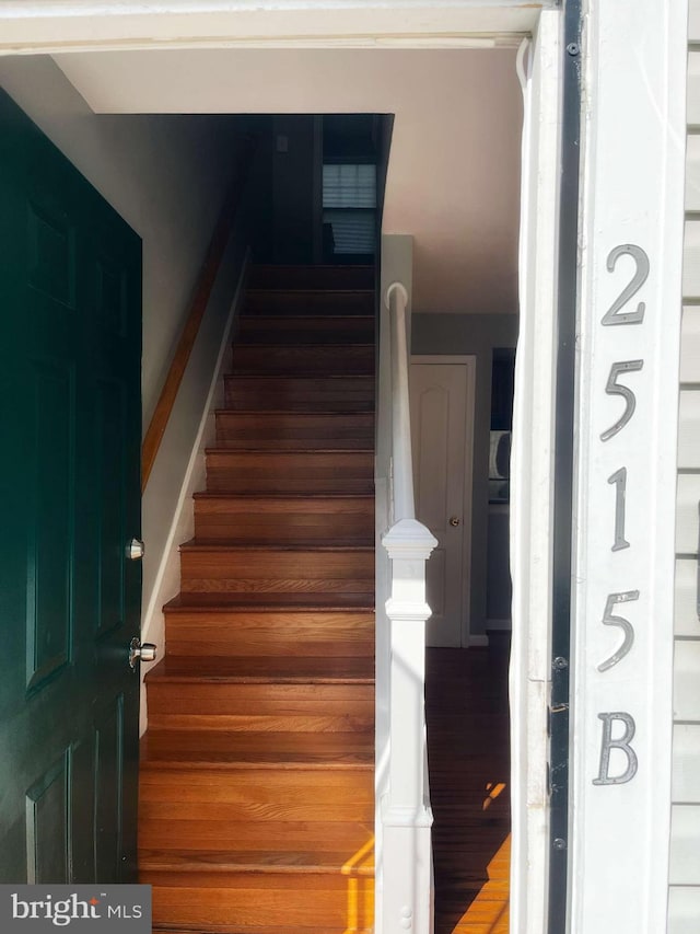 stairway with hardwood / wood-style flooring