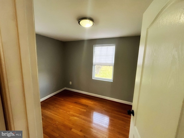 unfurnished room with hardwood / wood-style floors