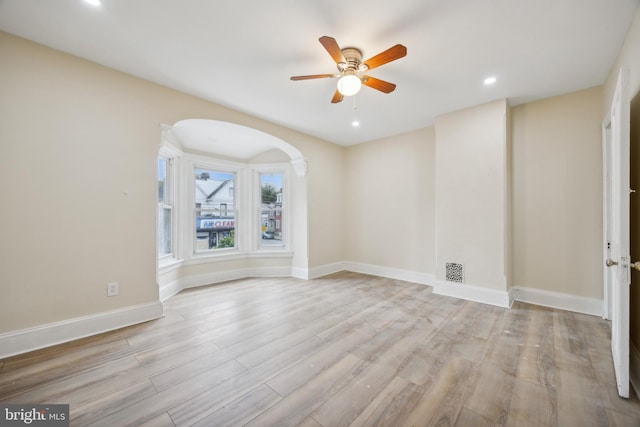 empty room with light hardwood / wood-style flooring and ceiling fan