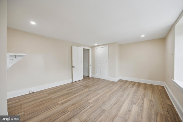 spare room with light hardwood / wood-style flooring