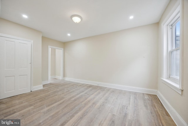 spare room featuring light hardwood / wood-style flooring and plenty of natural light