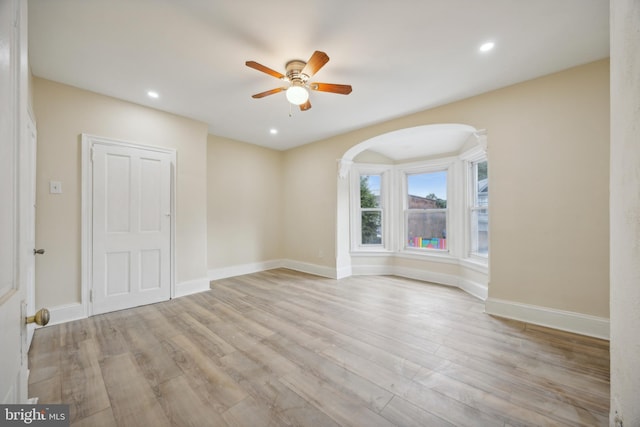 spare room featuring light hardwood / wood-style floors and ceiling fan