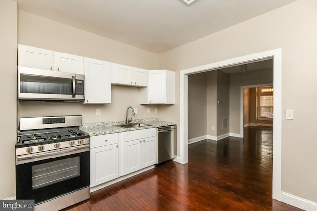 919 N Lakewood Ave, Baltimore, MD 21205 - kitchen featuring dark wood-style flooring, white cabinetry, a sink, and appliances with stainless steel finishes