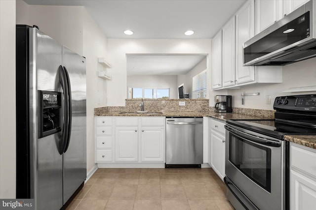 kitchen featuring appliances with stainless steel finishes, white cabinetry, and sink