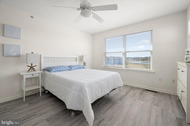 bedroom with light wood-type flooring and ceiling fan