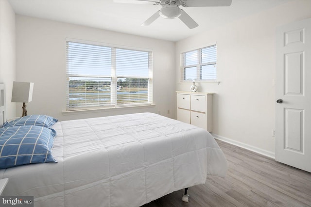 bedroom with ceiling fan and hardwood / wood-style floors