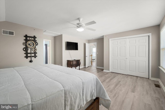 bedroom with a closet, light hardwood / wood-style flooring, and ceiling fan