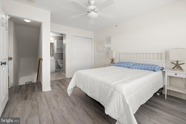 bedroom featuring ceiling fan, hardwood / wood-style flooring, a closet, and connected bathroom