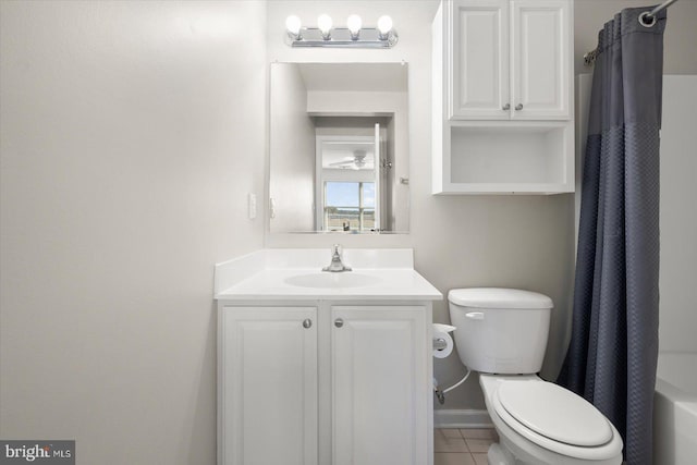 full bathroom with tile patterned floors, vanity, shower / bath combo with shower curtain, and toilet