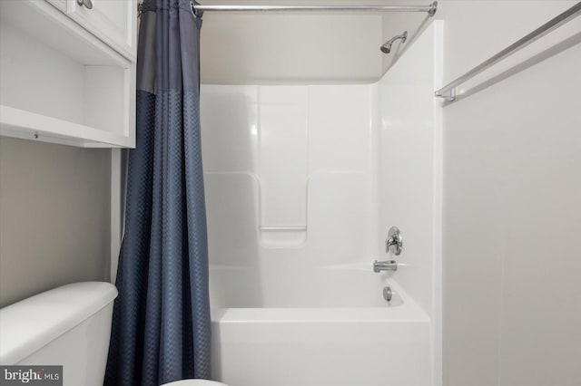 bathroom featuring shower / tub combo and toilet