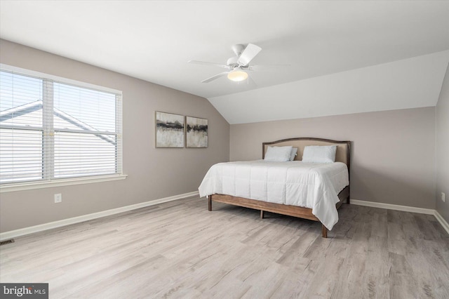 bedroom with lofted ceiling, ceiling fan, and light hardwood / wood-style floors