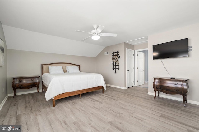 bedroom with vaulted ceiling, light hardwood / wood-style flooring, and ceiling fan