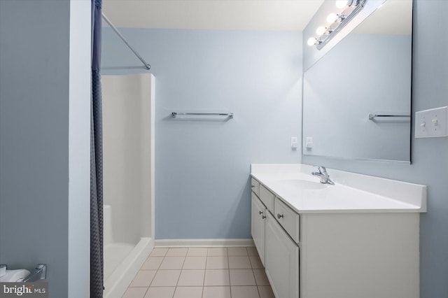 bathroom with walk in shower, vanity, and tile patterned floors