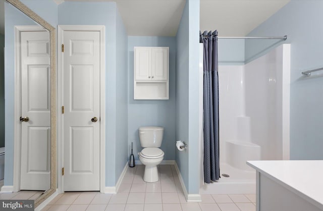 bathroom with a shower with curtain, tile patterned floors, vanity, and toilet