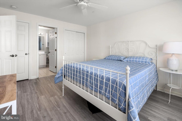 bedroom featuring wood-type flooring, a closet, ensuite bathroom, and ceiling fan