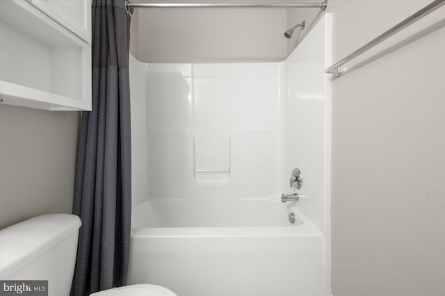 bathroom with toilet and shower / tub combo with curtain