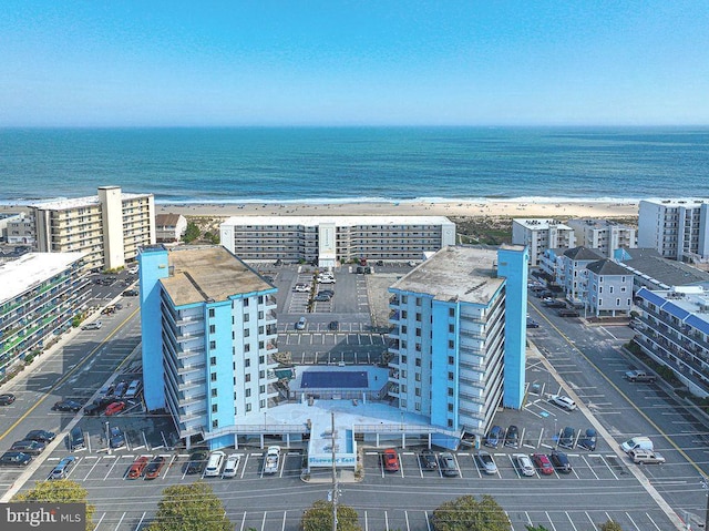 drone / aerial view with a beach view, a water view, and a view of city