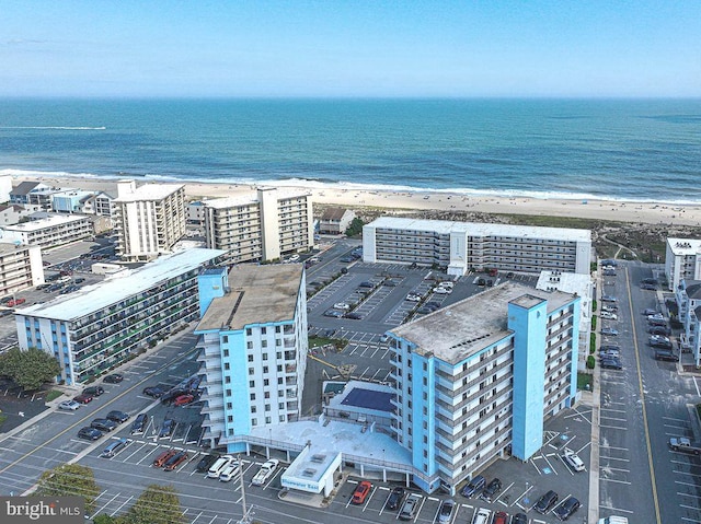 birds eye view of property with a view of the beach and a water view