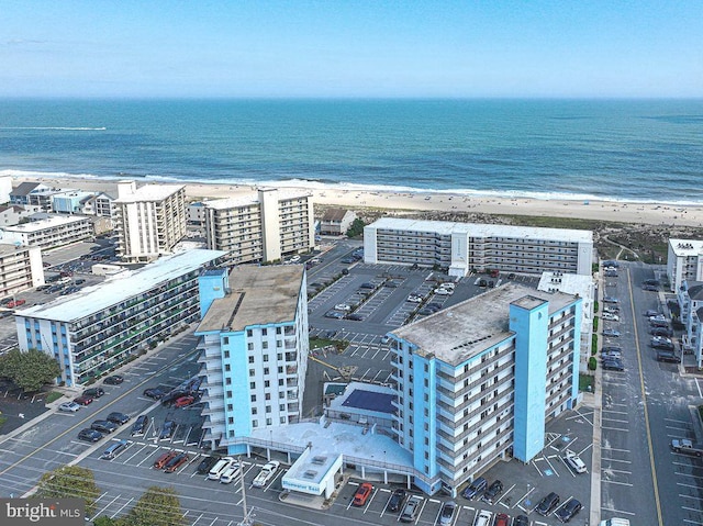 aerial view with a water view, a view of the beach, and a view of city