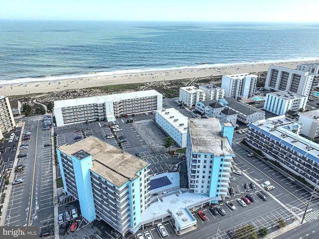 drone / aerial view featuring a water view and a view of the beach