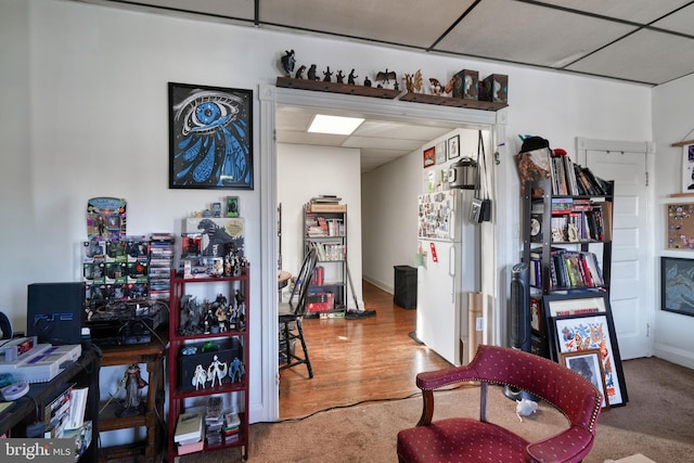 interior space featuring hardwood / wood-style flooring and a drop ceiling