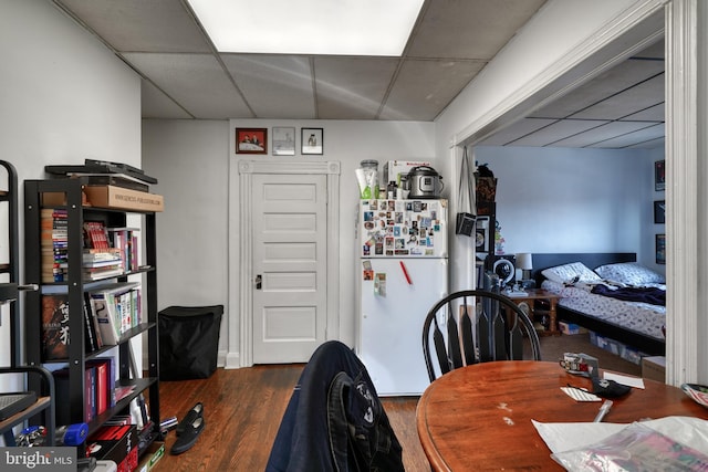 office with a paneled ceiling and dark wood-type flooring